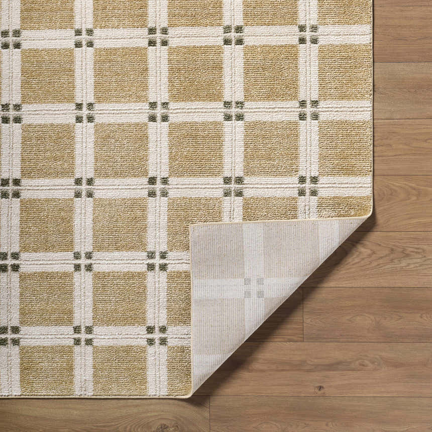 Close-up of the Kalkin Tan Area Rug. Tan and ivory grid pattern with small olive accents. Machine woven texture. Fold