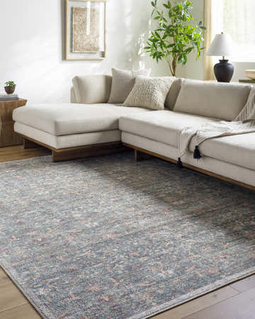 Living room with a sectional sofa and the Amasai Area Rug in gray, pink, and sage. Roomscene-Rectangle