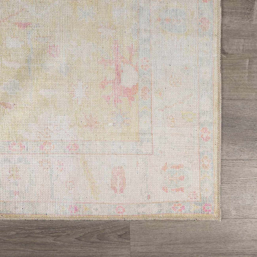 Close-up of Bozkurt Boutique Washable Rug showing vintage Persian design in lambswool, pink, and light blue colors. Swatch