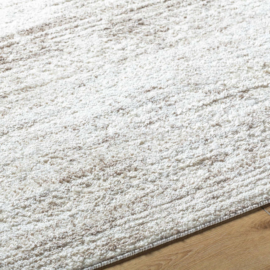 Close up of the textured Kohaku Light Gray Area Rug with beige and light brown accents. Texture