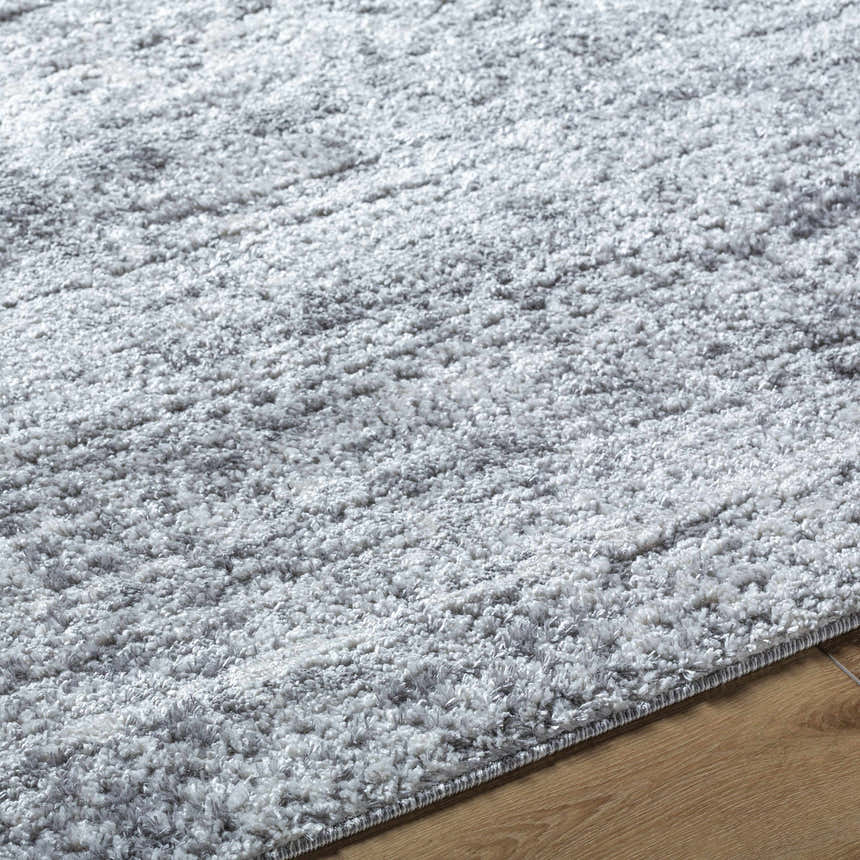 Close up of the plush, textured Kohaku Black Area Rug showing light gray, charcoal and black tones. Texture