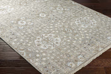 Close-up of the hand-knotted Limbalod Area Rug. Brown, charcoal, ice blue, light beige, and taupe oriental design. Corner