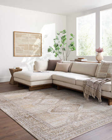 Light-filled living room with a beige sectional sofa and the tan and brown Ligeia Area Rug. Roomscene-Rectangle
