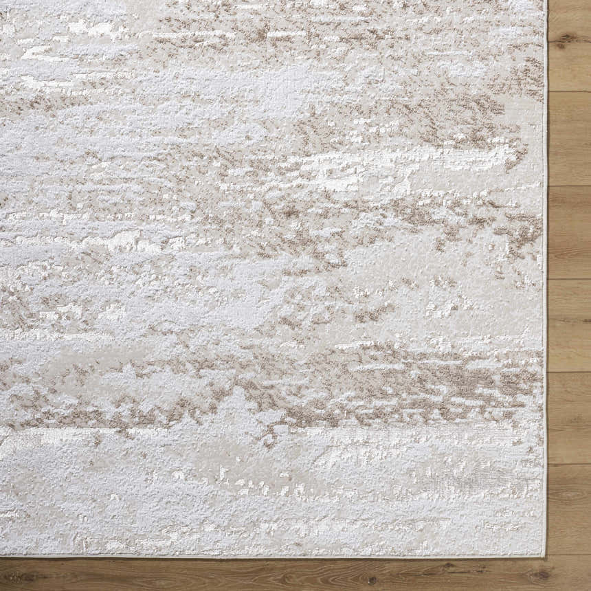 Close-up of the Arenda Tan Area Rug showing its cream and tan abstract pattern and soft, textured polyester material. Corner