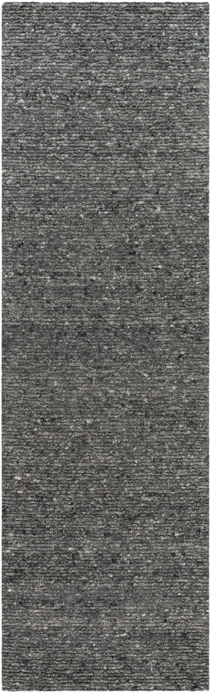 Close-up of the hand-tufted Winta Black Wool Area Rug. Gray, medium gray, and onyx tones with a subtle textured pattern. Design-Runner-310