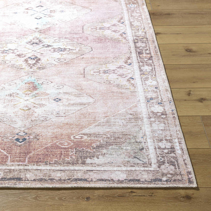 Close-up of the Ussun Washable Area Rug showing its beige, rust, and cream traditional design on wood floors. Front