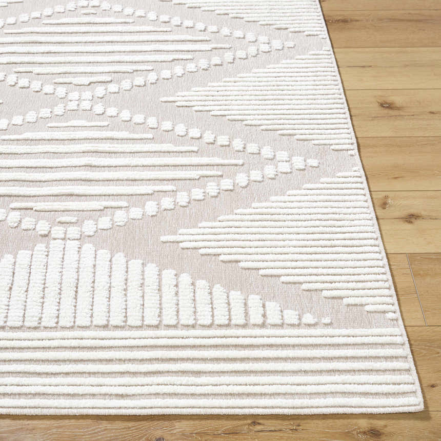 Close-up of the Annika Washable Area Rug; off-white textured geometric pattern on a tan background. Front