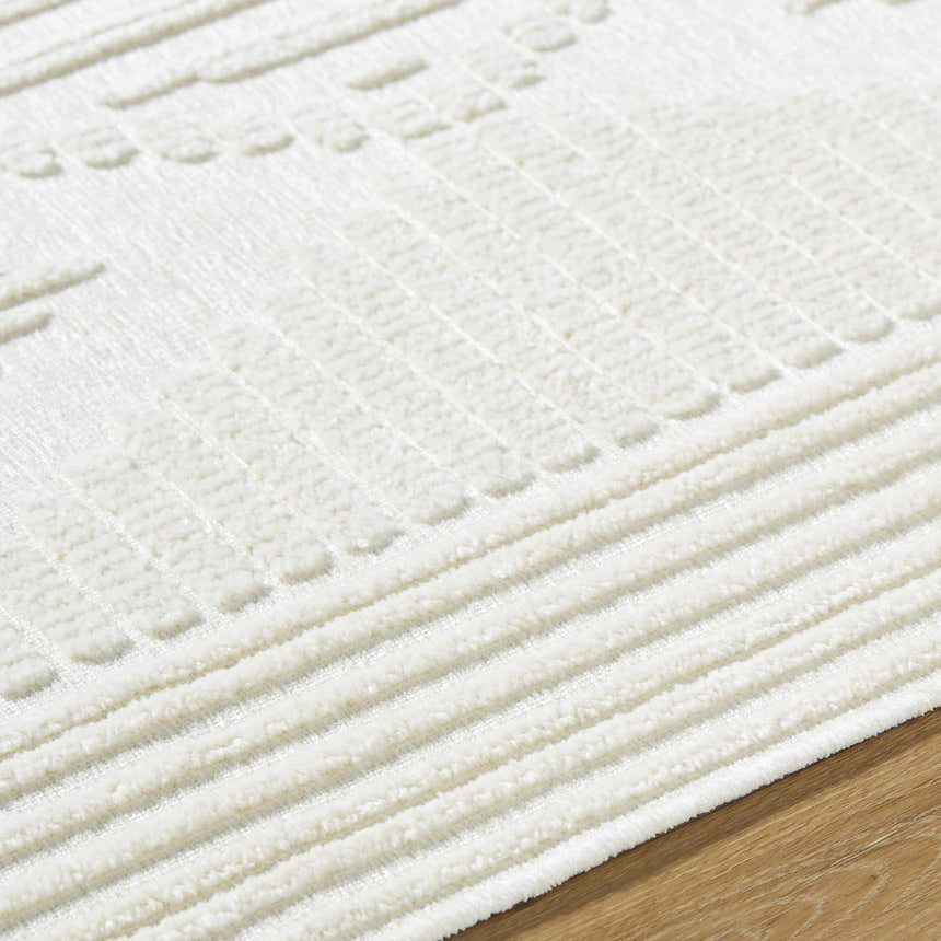 Close-up of the Annika Beige 3D Washable Area Rug, showcasing its raised geometric pattern and soft, textured pile. Texture