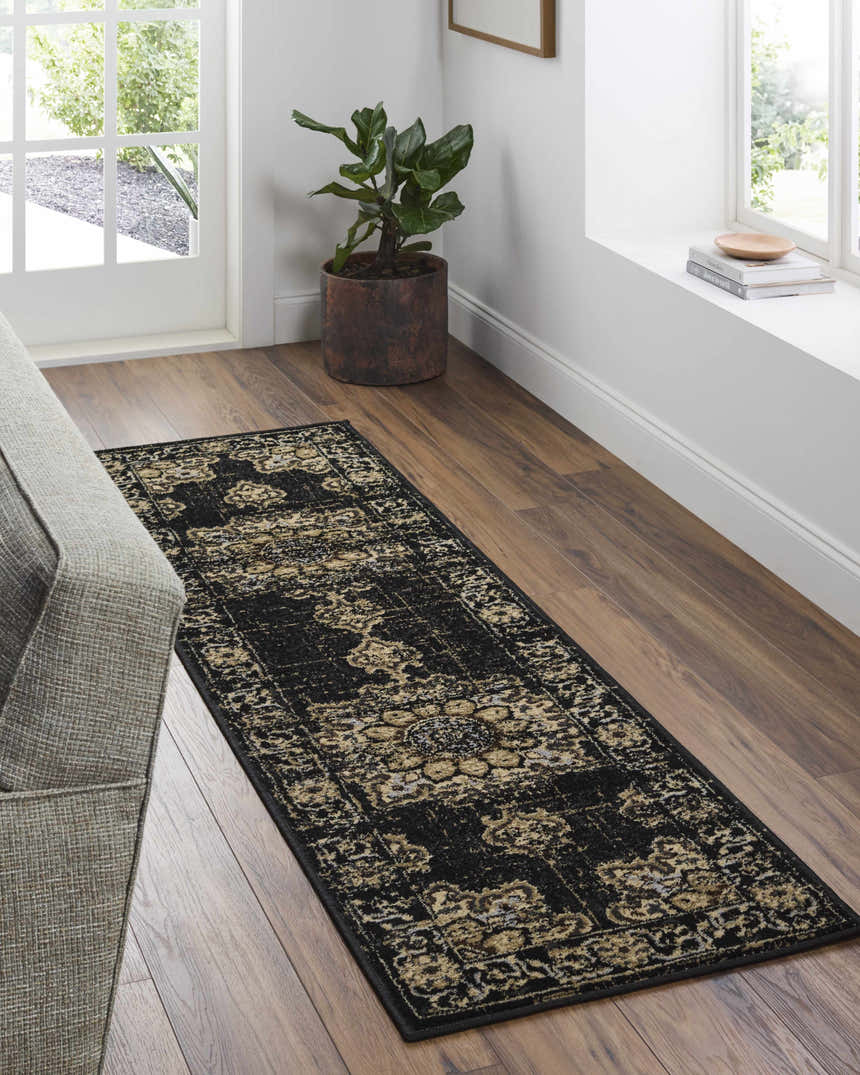 Entryway scene with a Lostwithiel Black Medallion Rug runner on wood floors, with a gray couch and natural light. Roomscene-Runner