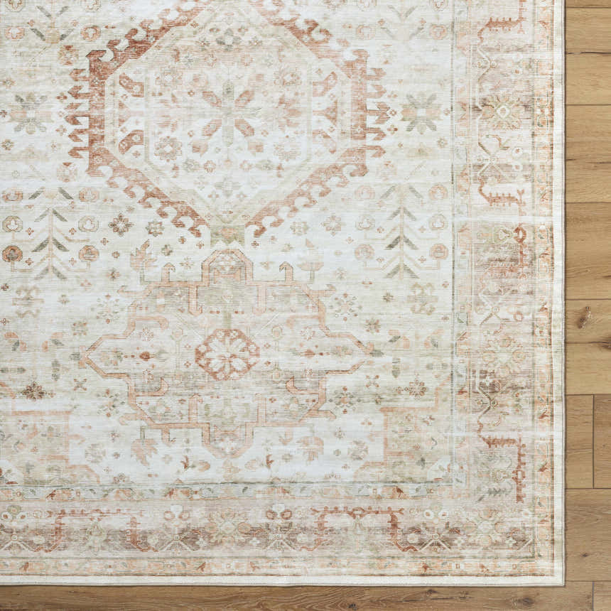 Close-up of Laran Rust Distressed Washable Area Rug showing traditional brick red, gray, and silver pattern on wood floor. Corner