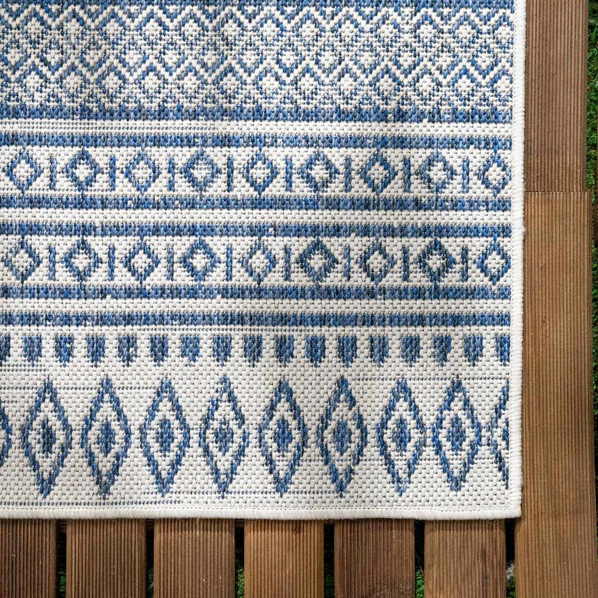 Close-up of the Madras Light Blue Green All Over Performance Area Rug with a geometric, bohemian-inspired pattern. Swatch
