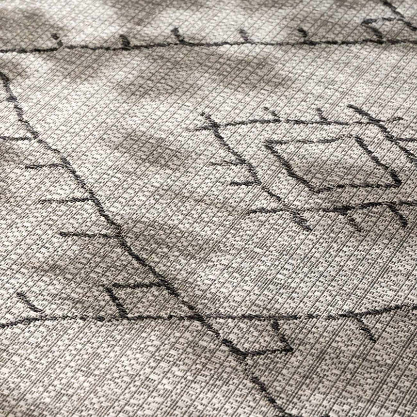 Close up of the Marwood Nordic Performance Rug featuring a geometric black and taupe pattern. Texture