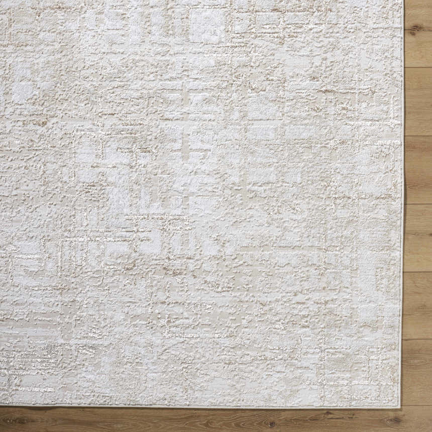 Close-up of the Auriel Beige Area Rug. Contemporary design with cream and tan hues, textured pattern. Corner