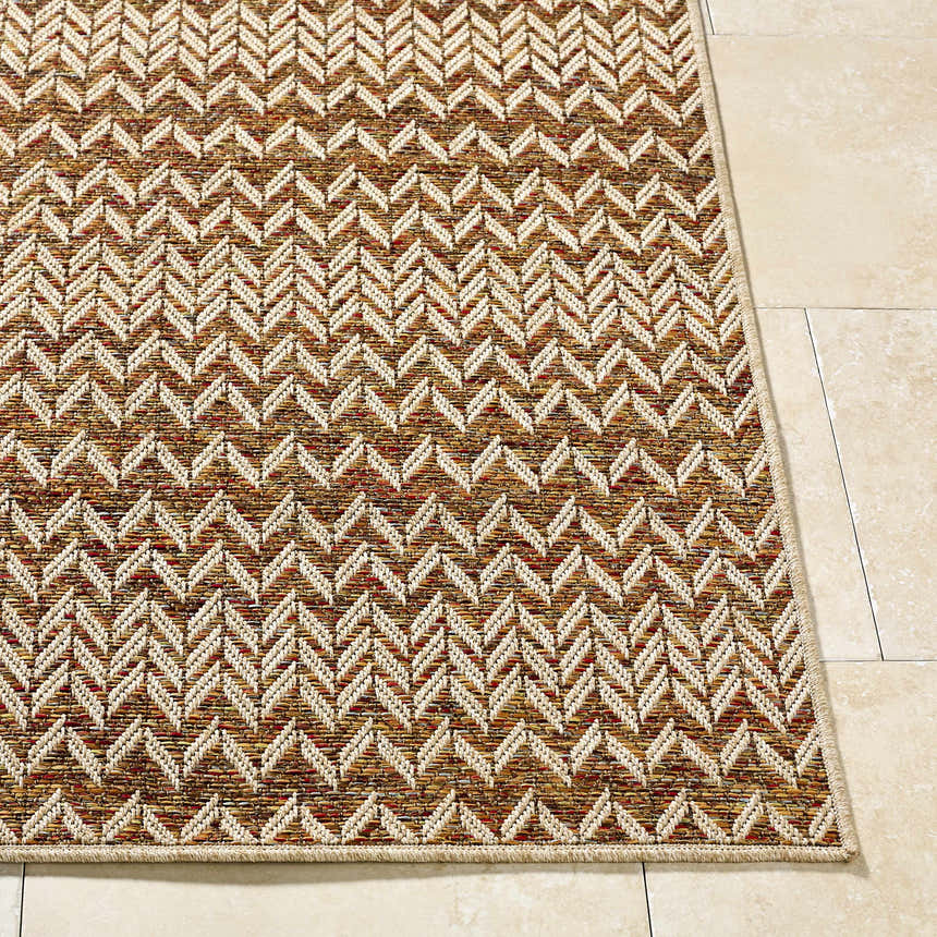 Close-up of Alazne Burnt Orange Area Rug. Woven texture with cream chevron pattern and terracotta, sandstone, and orange hues. Front