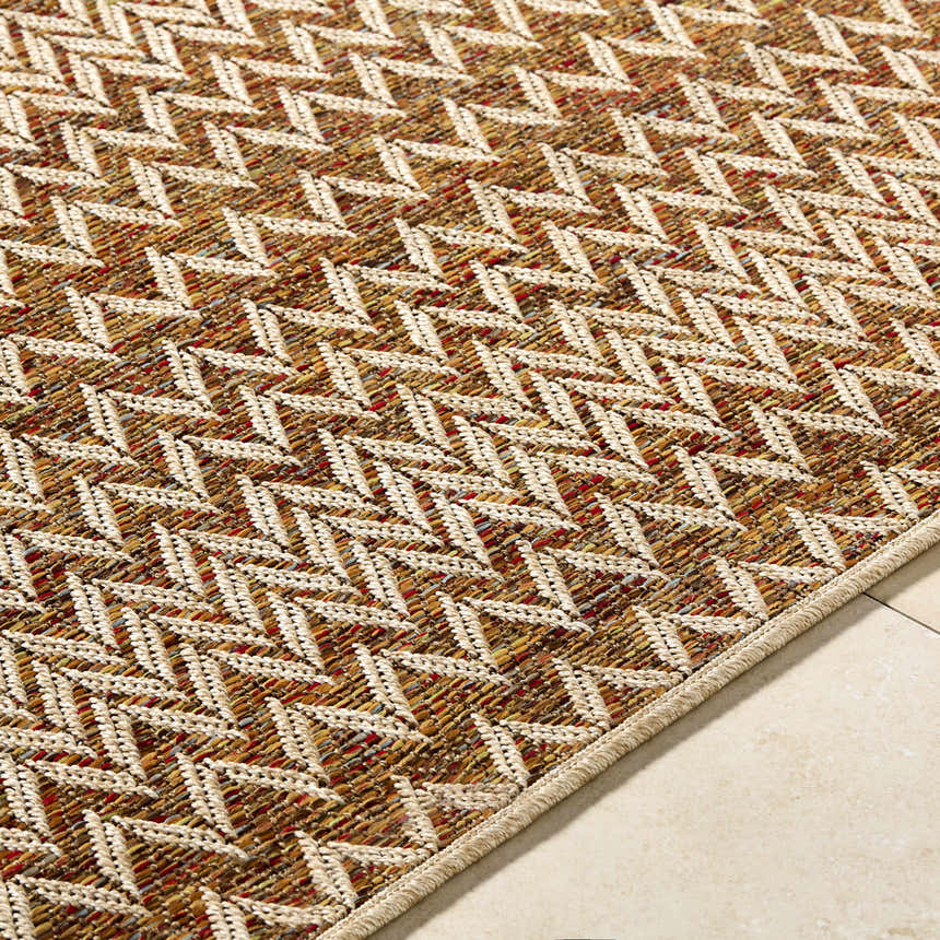 Close-up of the Alazne Burnt Orange Area Rug, showing its geometric pattern, woven texture, and warm colors. Texture