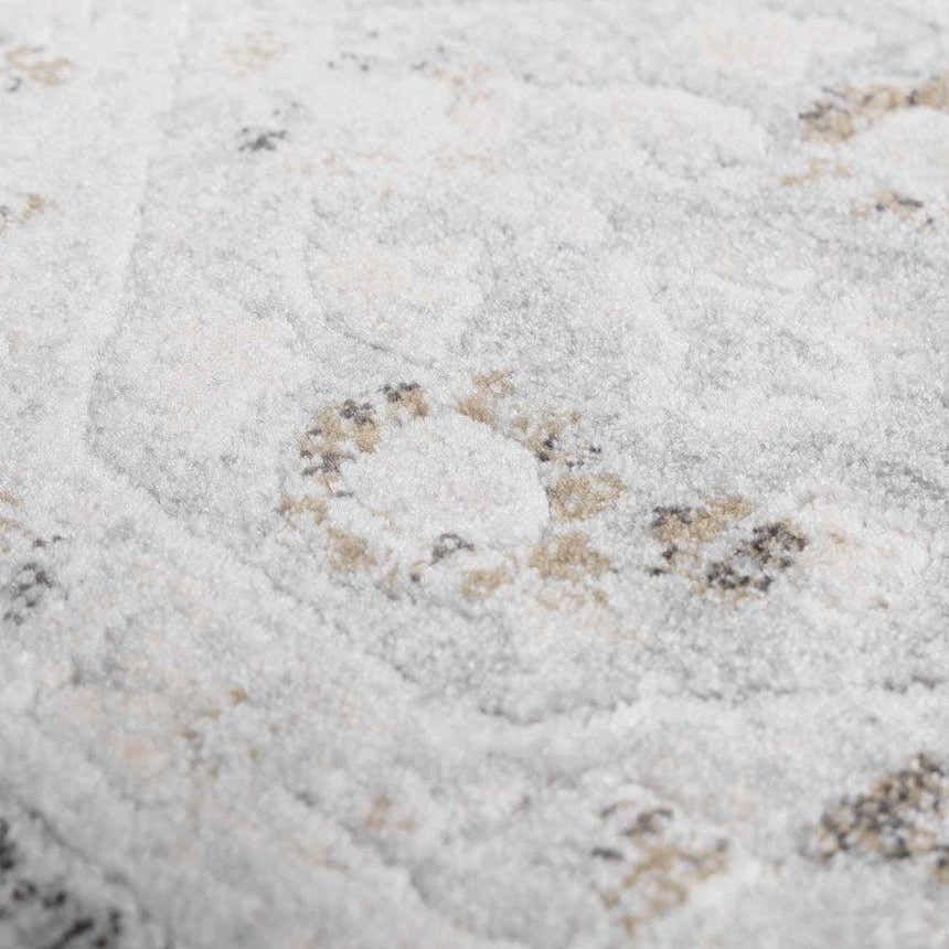 Close-up of the Minoa Area Rug, showcasing its beige, black, and gray bohemian pattern and soft, textured polypropylene weave. Texture