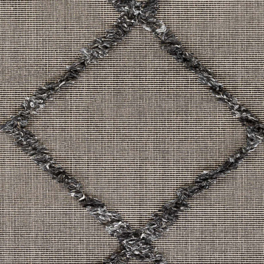 Close-up of the Mossman Brown Diamond High-Low Rug, featuring a textured gray diamond pattern on a black and beige woven background. Swatch