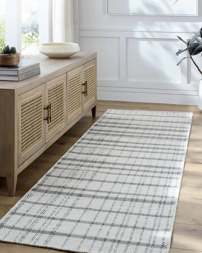 Entryway with a Nissa Ivory runner rug, light wood console table, and white walls. Roomscene-Runner