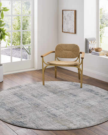 Bright living room with round Neron Thick Luxe Abstract Rug in blue, cream, and gray under a woven chair. Roomscene-Round