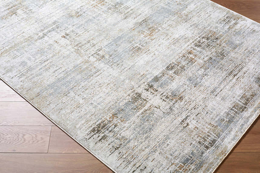 Close-up of Neron Blue Gray Thick Luxe Abstract Rug showing charcoal, cream, and brown abstract pattern on wood floor. Corner