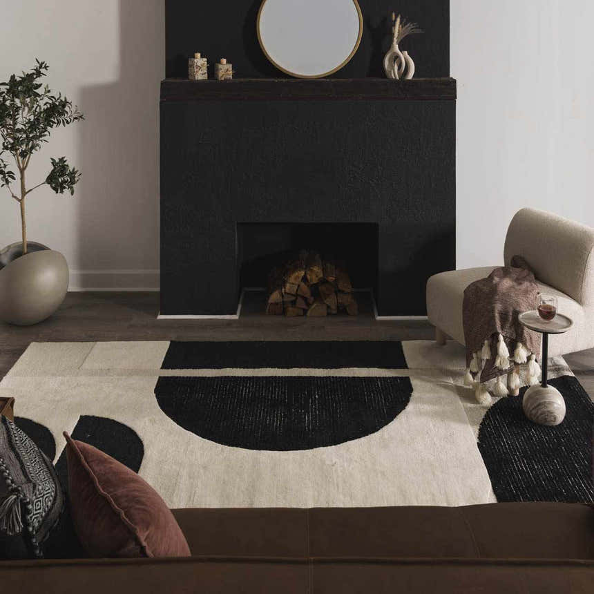 Living room with a black fireplace and the Brooklyn Modern hand tufted wool area rug in cream and black geometric design. Roomscene-Rectangle