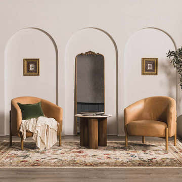 Living room scene with tan chairs and Neola White/Brown Oushak Rug featuring brick red, navy, and olive floral patterns. Roomscene-Rectangle