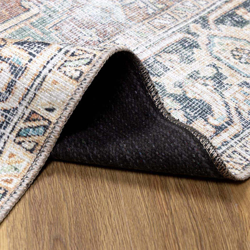 Close-up of the Green Nisa Tumble Dry Washable Rug showing its traditional Persian pattern, colors, and machine-woven construction. Fold