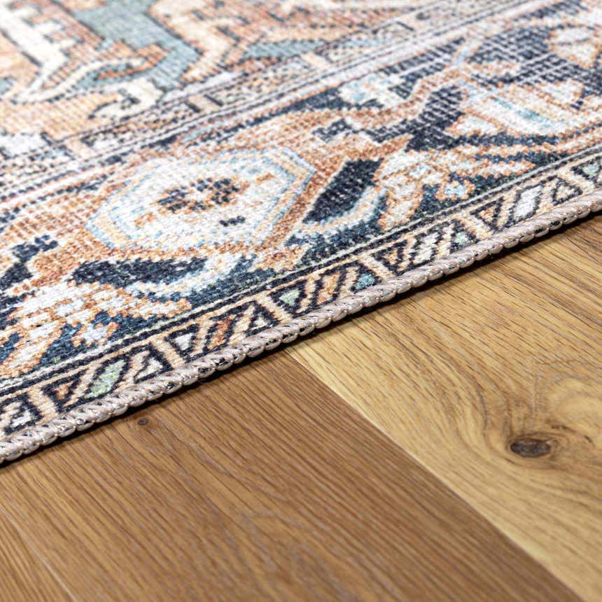 Close-up of Green Nisa Tumble Dry Washable Rug showing its Persian-style pattern, seafoam, navy, and orange colors. Corner