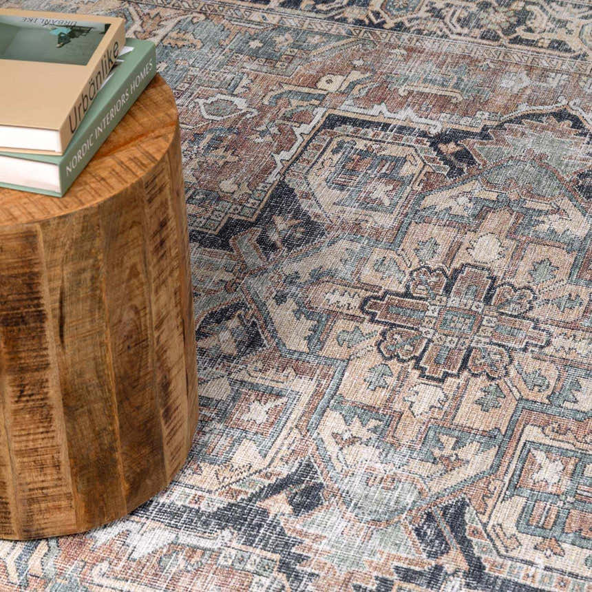 Close-up of the Green Nisa Tumble Dry Washable Rug, showcasing its traditional Persian-style pattern and seafoam, tan, and navy colors. Styleshot