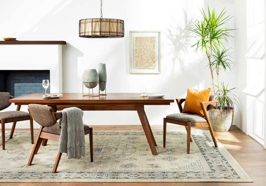 Dining room scene with a Niton Area Rug in beige, black, and blue under a wood table and chairs. Bohemian style. Roomscene-Rectangle