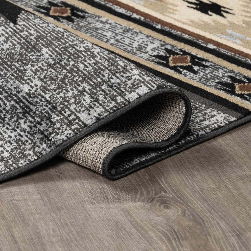 Close-up of the Buckhaven Area Rug showing its Southwestern pattern, colors, texture, and machine-woven construction. Fold