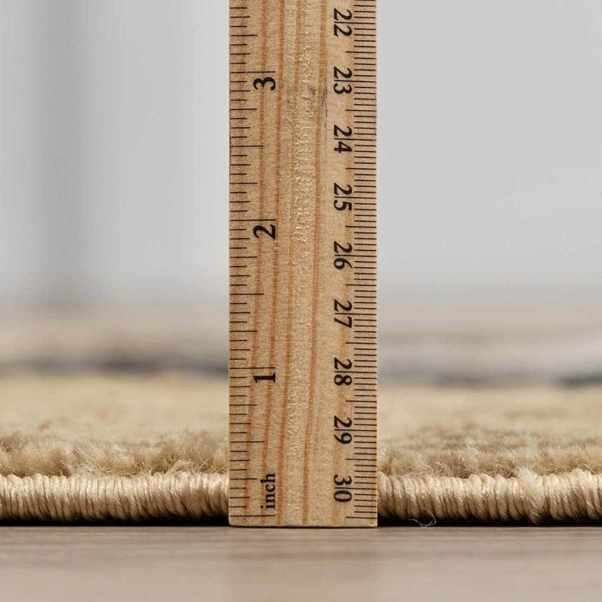 Close-up of the Buckhaven Brown Aztec Carpet showing pile height with a ruler. Pile