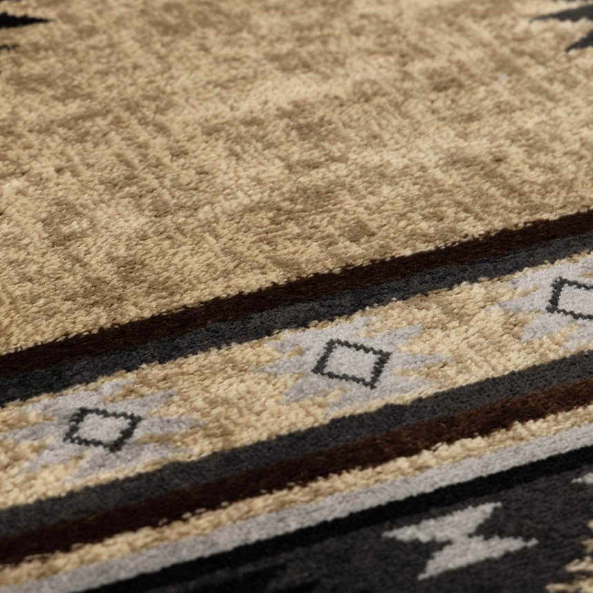 Close-up of the Buckhaven Brown Aztec Carpet showing its tan, black, gray, and brown geometric pattern and soft texture. Texture