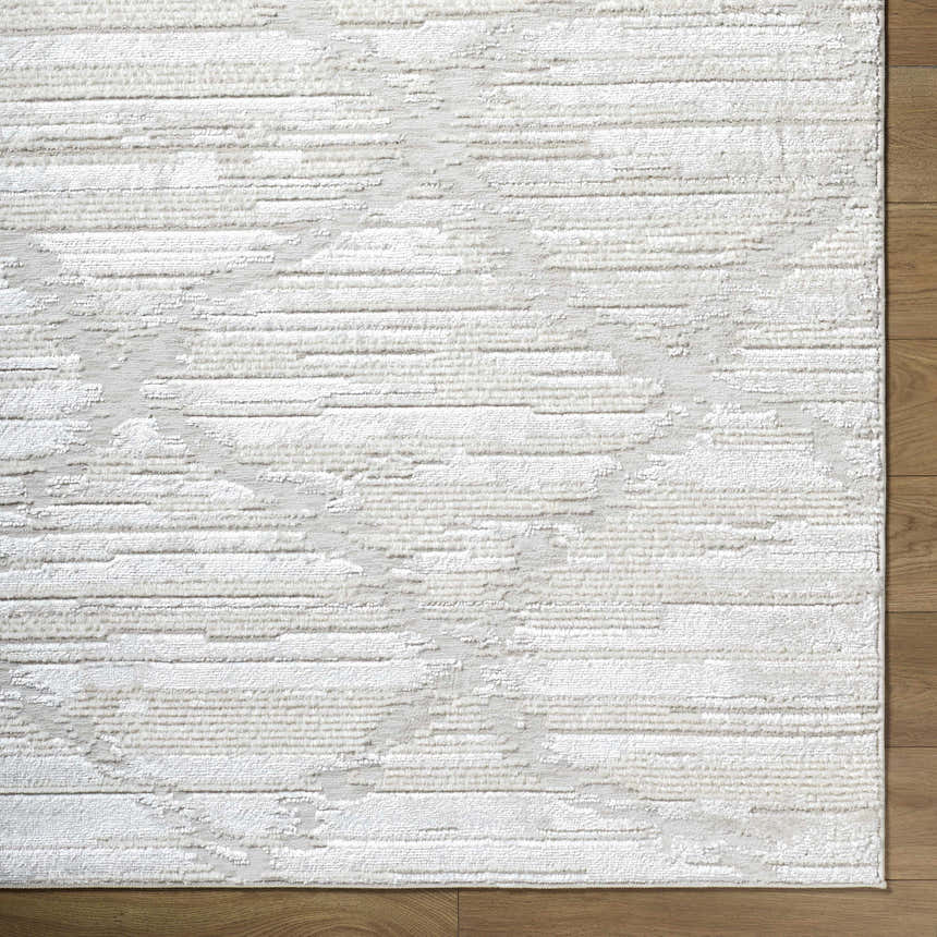 Close up of Akilah Area Rug showing cream, ivory, and light gray contemporary design and texture. Corner
