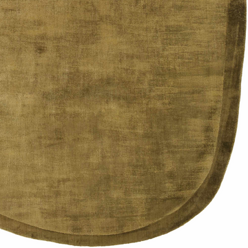 Close-up of the hand-loomed Kohou Green Solid Viscose Area Rug, showing its goldenrod and olive colors and soft texture. Corner