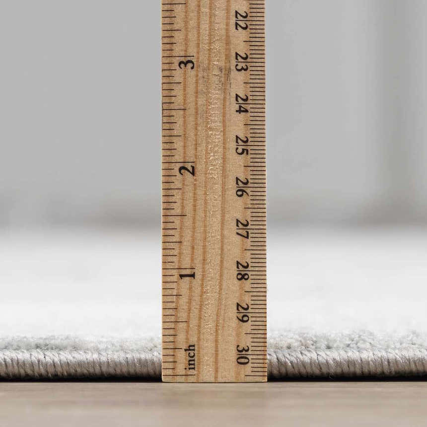 Close-up of the Pialba Thick Luxe Abstract Smokey Rug showing its plush texture and thickness with a ruler for scale. Pile