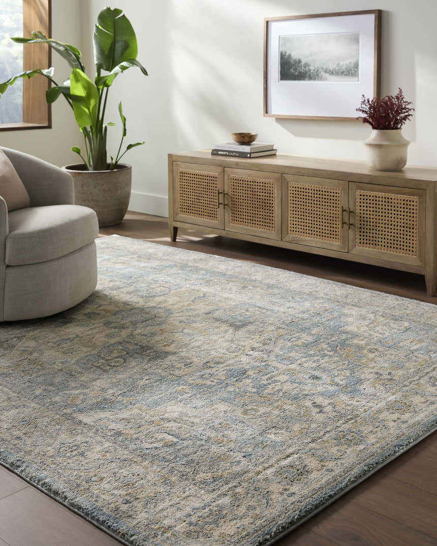 Living room scene with a beige Akshay Thick Luxe Area Rug, gray chair, and wood console table. Roomscene-Rectangle