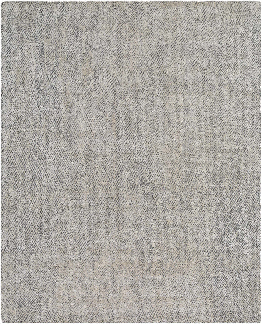 Close-up of the Pantubig Area Rug. Hand-loomed rug in charcoal, gray, ivory, and light beige with a subtle textured pattern. Design-Rectangle-810