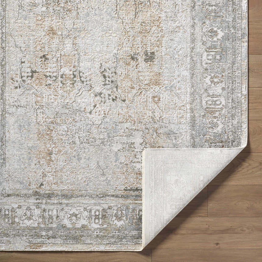 Close-up of the Pryce Sage Thick Luxe Area Rug showing its traditional design, charcoal, cream, and light brown colors. Fold