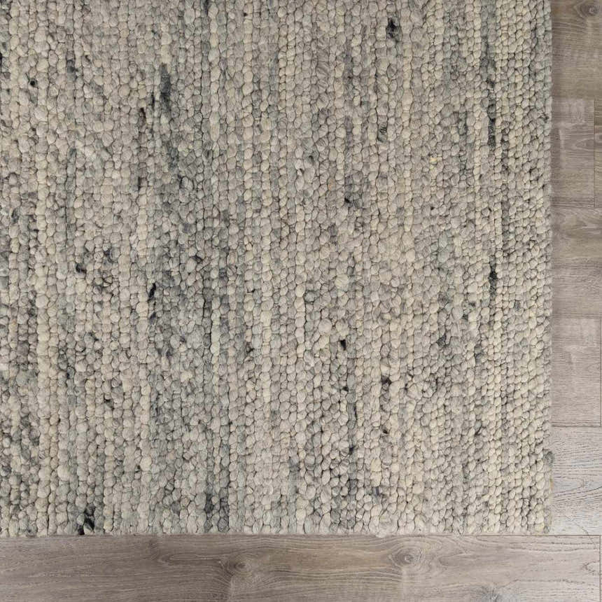 Close-up of the Olisa Gray Wool Area Rug showing its hand woven texture and light gray and natural gray color variations. Swatch