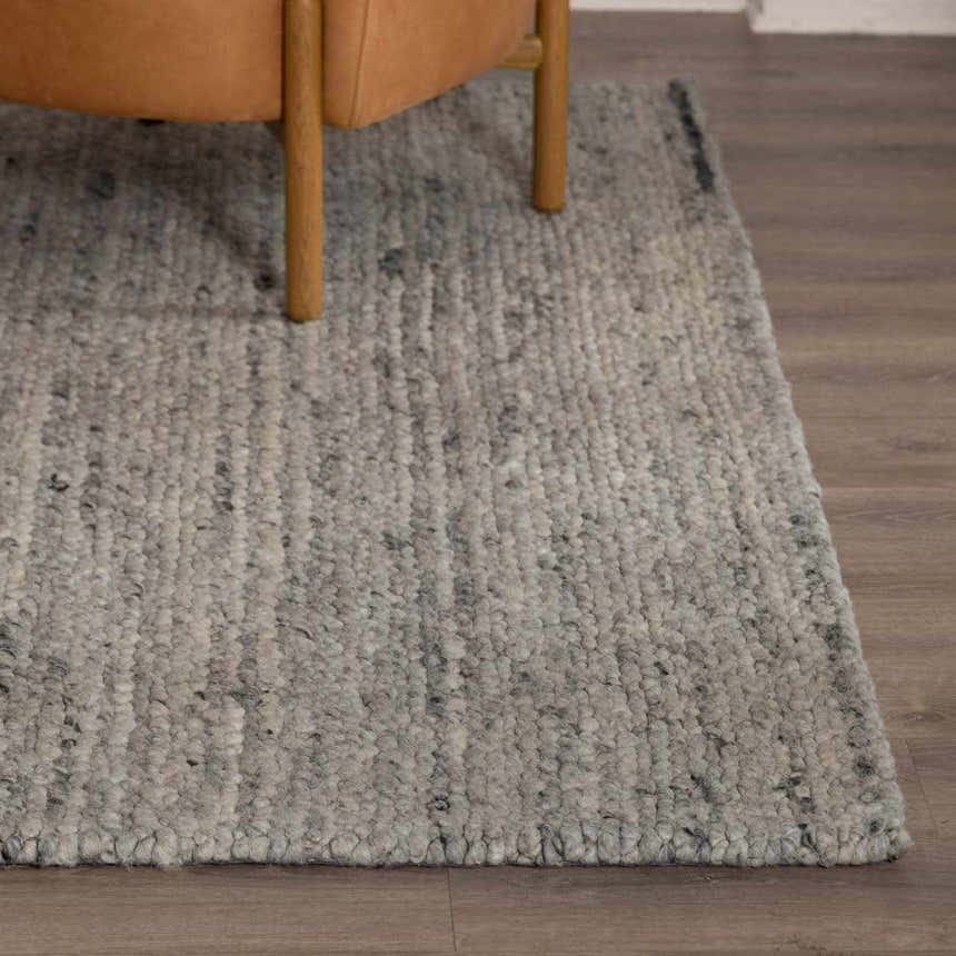 Close-up of the Olisa Gray Wool Area Rug showing its chunky weave, light gray tones, and subtle natural gray flecks. Front