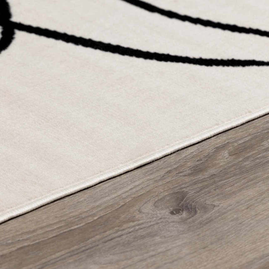 Close up of the Bone Eilir Modern Boho Rug showing black abstract design and texture. Pile