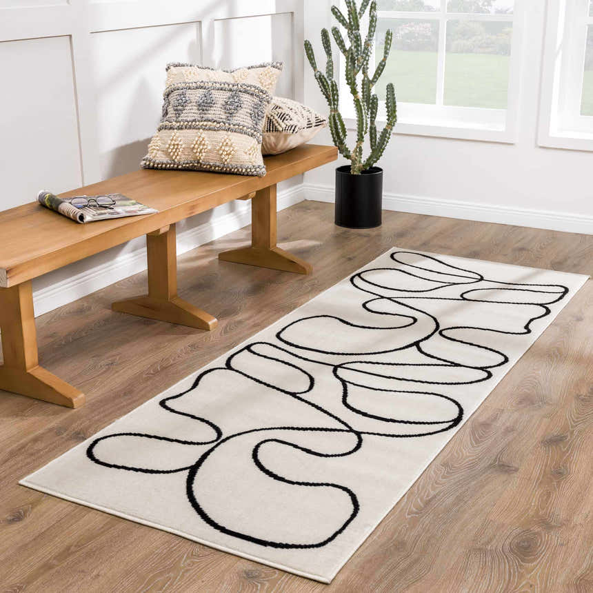 Entryway with wood bench, cactus, and Eilir Modern Boho Runner Rug in bone and black. Roomscene-Runner