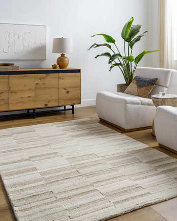 Living room with neutral decor and Amrita Ivory area rug. Beige geometric rug under light armchairs. Roomscene-Rectangle