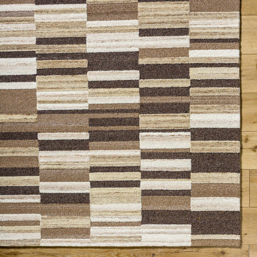 Close-up of the Amrita Beige Area Rug. Hand-tufted wool rug with beige, cream, tan, and brown geometric block pattern. Corner