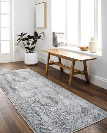 Entryway with Annlea Washable Area Rug in blue and sage, wood bench, potted plant, and bright natural light. Roomscene-Runner