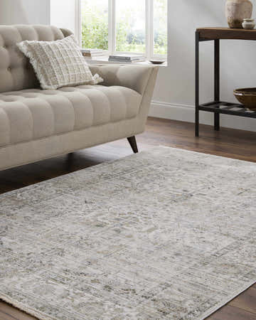 Living room scene with a beige sofa and the charcoal and gray Allaun Area Rug. Roomscene-Rectangle