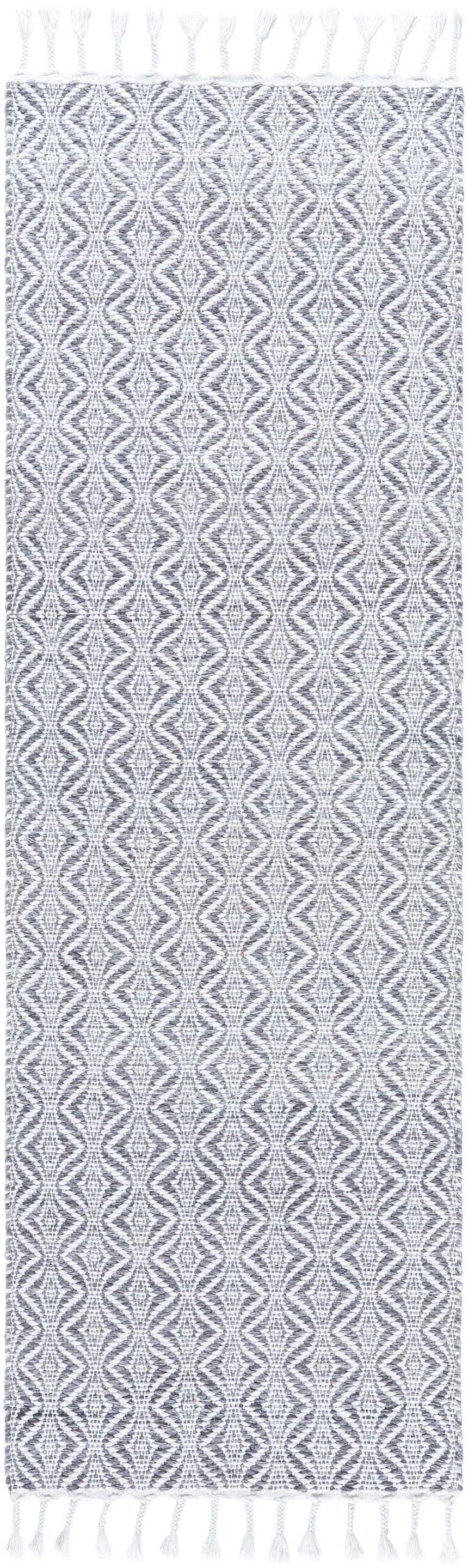 Close-up of the Anelia Medium Gray Area Rug. Hand-woven rug with dove gray and ivory diamond pattern and tassels. Design-Runner-268