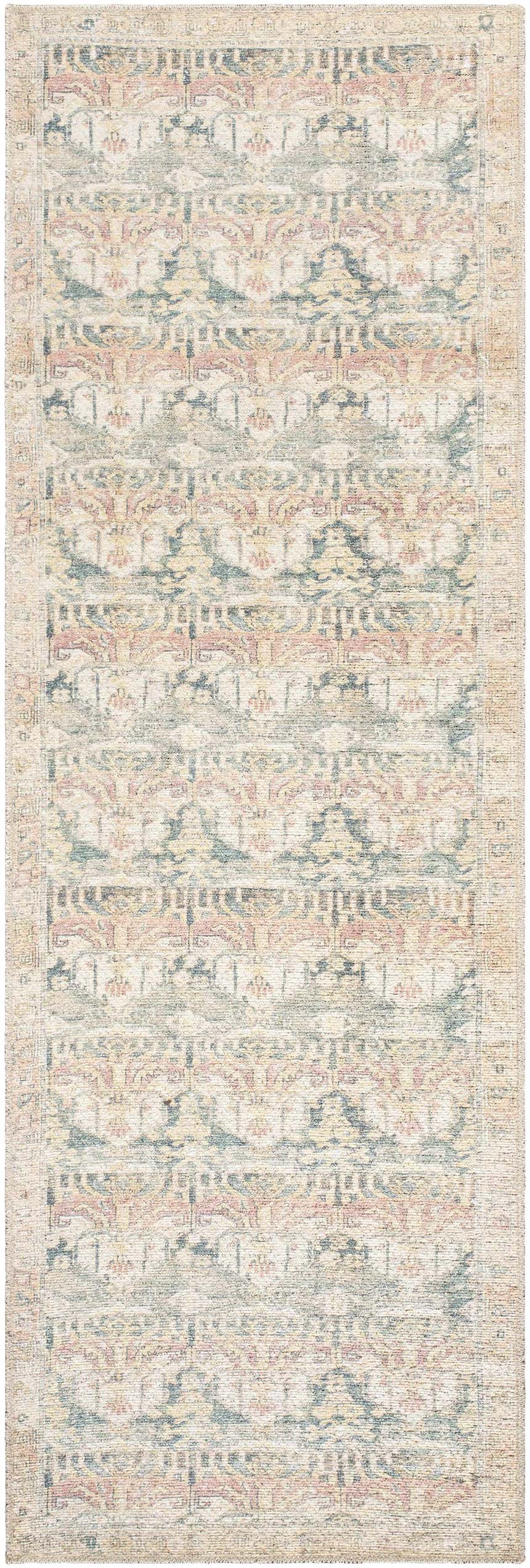 Close-up of the Arushi Washable Area Rug, a cream rug with traditional rust, orange, and green geometric patterns. Design-Runner-27710