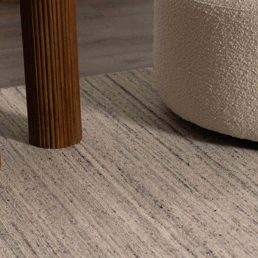 Close-up of the hand-tufted Capote Charcoal Area Rug, with charcoal and ivory linear design and wool texture. Roomscene-Rectangle